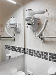a bathroom with a shower and a mirror and a toilet at Brit Hotel Le Surcouf in Saint Malo +72 photos