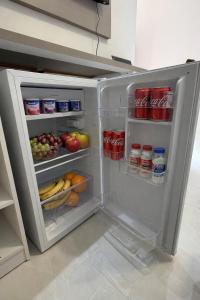 an open refrigerator filled with lots of food and drinks at Loft Brisas do Caeté in Bragança