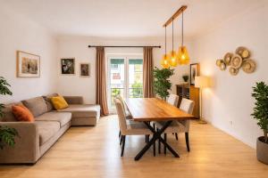 a living room with a table and a couch at Cascais Ocean Apartment in Cascais
