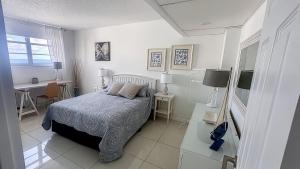 a white bedroom with a bed and a desk and a desk at THE TIDES 2bedrooms apt 14th floor WE ARE ON THE BEACH! in Hollywood