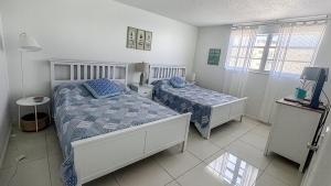 a bedroom with two beds and a tv in it at THE TIDES 2bedrooms apt 14th floor WE ARE ON THE BEACH! in Hollywood