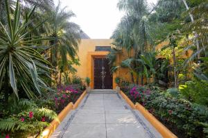 a walkway leading to a door in a garden at Casa Tara Villa Oceanfront Oasis Private Beach in Cruz de Huanacaxtle