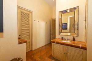 a bathroom with a sink and a mirror at Casa Tara Villa Oceanfront Oasis Private Beach in Cruz de Huanacaxtle +33 photos
