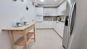 a kitchen with white cabinets and a refrigerator at THE TIDES 2bedrooms apt 14th floor WE ARE ON THE BEACH! in Hollywood