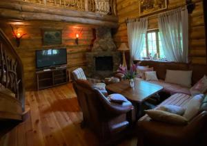 a living room with a couch and a table at Lisotel in Rokytne