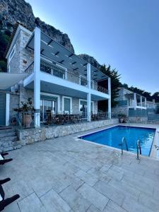 a villa with a swimming pool and a house at Villa Korina in Nea Epidavros +53 photos
