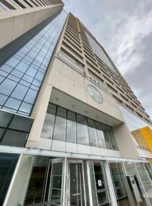 a building with a clock on the side of it at Prime Stay 2102 in Guarulhos