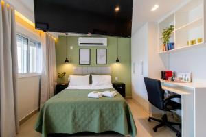 a bedroom with a bed with a desk and a computer at Prime Stay 2102 in Guarulhos +53 photos