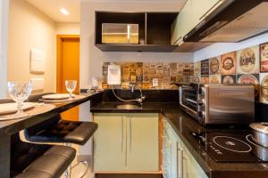 a kitchen with a sink and a stove top oven at Prime Stay 2102 in Guarulhos