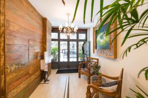 a hallway with a wooden wall and a chandelier at Hotel Fabris in Nova Friburgo +84 photos