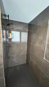 a bathroom with a shower with a glass door at Ferienwohnung Nella in Paderborn