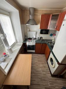 a small kitchen with a sink and a stove at Standarta 2 istabas dzīvoklis in Aizkraukle