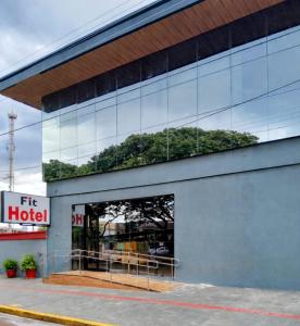a building with a reflection of trees in the windows at Fit hotel in Dourados