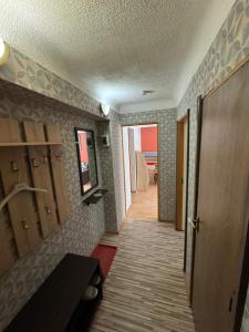 a hallway with a room with a door and a room with a table at Standarta 2 istabas dzīvoklis in Aizkraukle