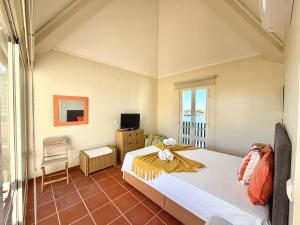 a bedroom with a large bed and a television at Marina Plaza by Garvetur in Vilamoura
