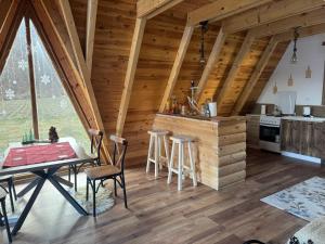 a kitchen and dining room in a log cabin at Balic Inn in Gusinje