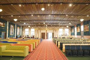 a large room with rows of tables and chairs at pearl green's in Anandpur Sāhib