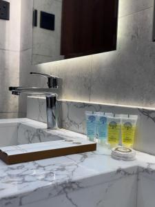 a bathroom counter with a sink and a mirror at دار مسك الفندقية in Medina
