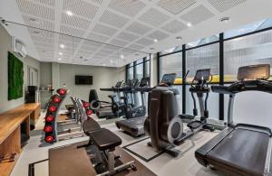 a gym with several treadmills and cardio machines at The Parade - Cardiff - 10 Min Walk to City Centre in Cardiff