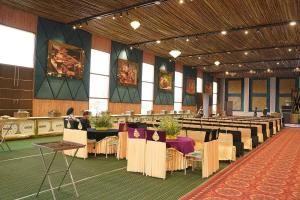 a large hall with tables and chairs in it at pearl green's in Anandpur Sāhib +13 photos