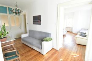 a living room with a couch and a chair at Panorama in Aurisina