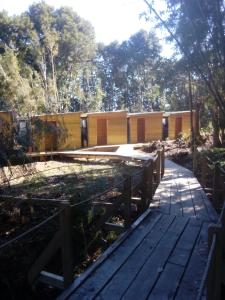 a house under construction with a wooden walkway at Alojamiento junto al mar in Chaitén +7 photos