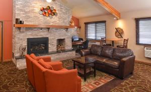 a living room with a couch and a fireplace at AmericInn by Wyndham Fergus Falls Conference Center in Fergus Falls