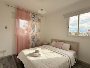 a bedroom with a large bed with a window at Zinas modern flat Nicosia in Strovolos