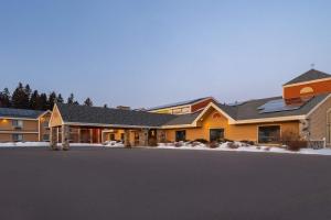 a house with a driveway in front of it at AmericInn by Wyndham Tofte Near Lake Superior in Tofte