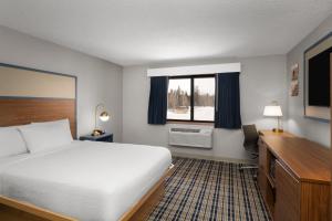 a hotel room with a bed and a desk and a window at AmericInn by Wyndham Tofte Near Lake Superior in Tofte +48 photos