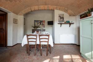 a dining room with a table with two chairs at Agriturismo Rebarco in Borsecchio