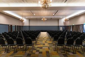 an empty hall with chairs and a chandelier at Esplendor by Wyndham Mendoza in Mendoza +67 photos