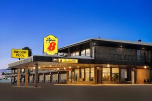 a building with a sign in front of it at Super 8 by Wyndham Hearst ON in Hearst