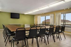a conference room with a large table and chairs at Super 8 by Wyndham Hearst ON in Hearst +59 photos