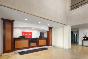 a lobby with a reception desk in a building at Ramada Suites by Wyndham San Diego Hotel Circle Area in San Diego +25 photos