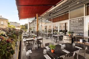 a restaurant with tables and chairs on a patio at Vienna House by Wyndham Andel's Cracow in Krakow