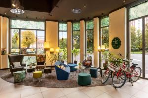 a lobby with bikes parked in a room with windows at Sunday Hotel Leipzig in Leipzig