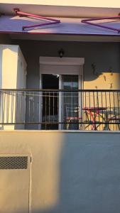 a balcony of a house with a table and chairs at Mermaid house in Drama