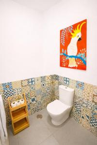a bathroom with a toilet and a picture of a rooster at Cascais Ocean Apartment in Cascais +4 photos