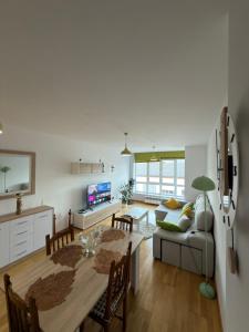 a living room with a table and a couch at Villa Arán in Negreira