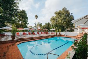 a swimming pool with chairs and umbrellas at a hotel at Céline & Lolo in Nairobi