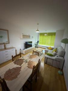 a living room with a table and a couch at Villa Arán in Negreira +9 photos