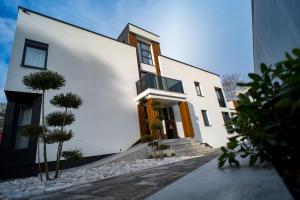 a white house with some trees in front of it at The Hill Aparthotel in Mostar