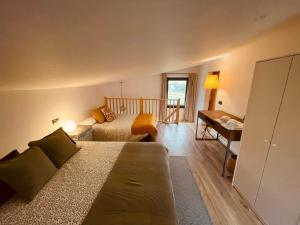 a living room with a bed and a desk at Alojamiento Rural Montseny in Breda