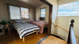 a small bedroom with a bed and a window at SECONDHOUSE WINTER - Vacation STAY 24982v in Kita-hamachō