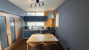 a kitchen with blue cabinets and a wooden table at SECONDHOUSE WINTER - Vacation STAY 24982v in Kita-hamachō