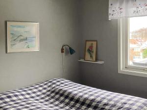 a bedroom with a bed and a lamp and a window at 4 person holiday home in Nordkoster in Strömstad +23 photos