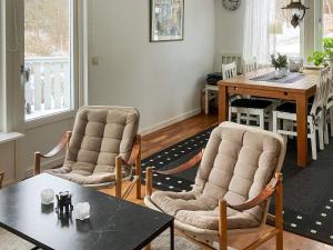 a living room with two chairs and a table at 4 person holiday home in Nordkoster in Strömstad