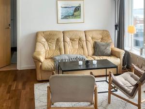 a living room with a couch and a table at 4 person holiday home in Nordkoster in Strömstad