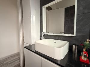 a bathroom with a white sink and a mirror at Zinas modern flat Nicosia in Strovolos +21 photos